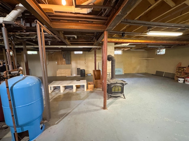 124 Swan Rd, Hermon, ME 04401 - basement with a water pressure tank and a wood stove