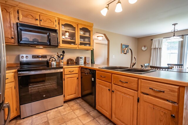 52A Judkins Rd, Harmony, ME 04942 - kitchen with black appliances, a sink, arched walkways, a peninsula, and light countertops