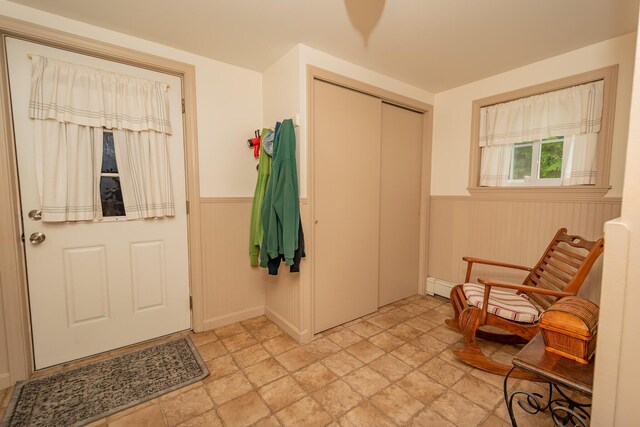 52A Judkins Rd, Harmony, ME 04942 - entrance foyer with a wainscoted wall, stone finish flooring, and a baseboard radiator