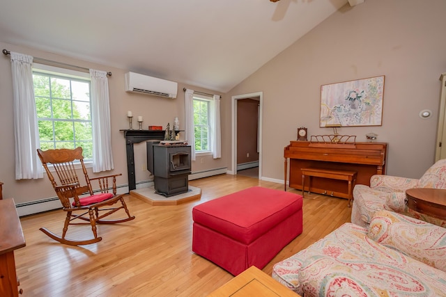 52A Judkins Rd, Harmony, ME 04942 - living area featuring a wall unit AC, a wood stove, light wood-type flooring, ceiling fan, and high vaulted ceiling