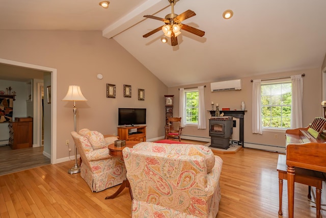 52A Judkins Rd, Harmony, ME 04942 - living area with a wall unit AC, a wood stove, a baseboard radiator, light wood-type flooring, and a ceiling fan
