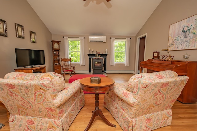 52A Judkins Rd, Harmony, ME 04942 - living area with a wall mounted air conditioner, lofted ceiling, light wood-style floors, and a baseboard heating unit