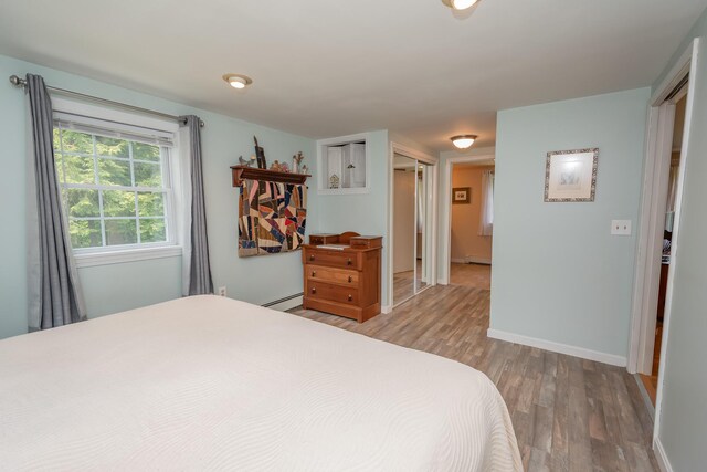 52A Judkins Rd, Harmony, ME 04942 - bedroom featuring wood finished floors, a baseboard heating unit, and baseboards