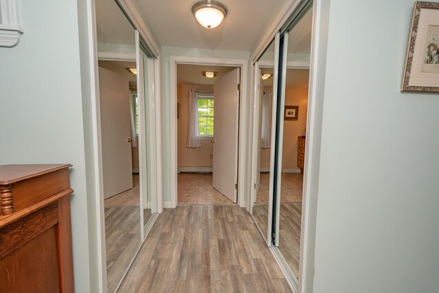 52A Judkins Rd, Harmony, ME 04942 - hall featuring light wood-style flooring, a baseboard radiator, and baseboards