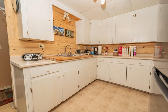 52A Judkins Rd, Harmony, ME 04942 - kitchen featuring light countertops, white cabinetry, a sink, and wood walls