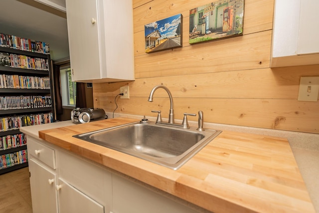 52A Judkins Rd, Harmony, ME 04942 - kitchen with butcher block counters, a sink, white cabinets, and wooden walls
