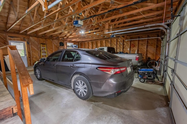 52A Judkins Rd, Harmony, ME 04942 - garage with wooden walls and a garage door opener