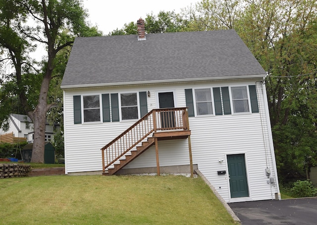 31 Curtis St, South Portland, ME 04106 - view of front of house with a chimney, a front lawn, stairs, and a shingled roof
