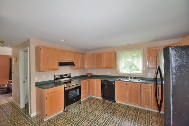 31 Curtis St, South Portland, ME 04106 - kitchen with black appliances, under cabinet range hood, light flooring, dark countertops, and recessed lighting