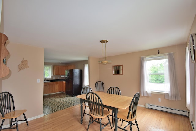 31 Curtis St, South Portland, ME 04106 - dining area with a baseboard heating unit and light wood finished floors
