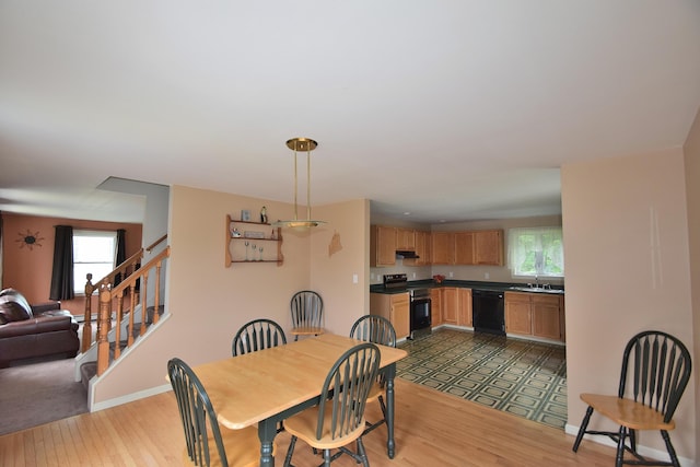 31 Curtis St, South Portland, ME 04106 - dining space with plenty of natural light, light wood-style flooring, and stairs