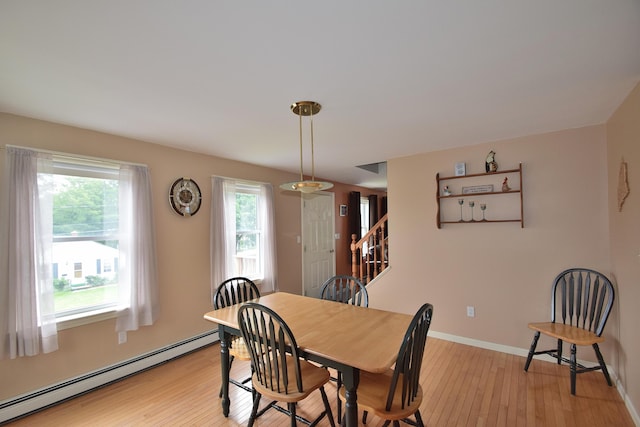 31 Curtis St, South Portland, ME 04106 - dining room with baseboard heating, healthy amount of natural light, and light wood finished floors