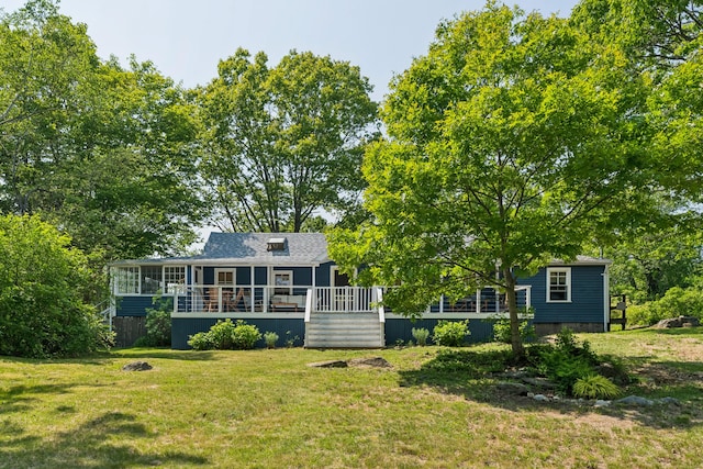 74 Ottawa Ave, Portland, ME 04109 - back of property with a yard, a deck, and a sunroom