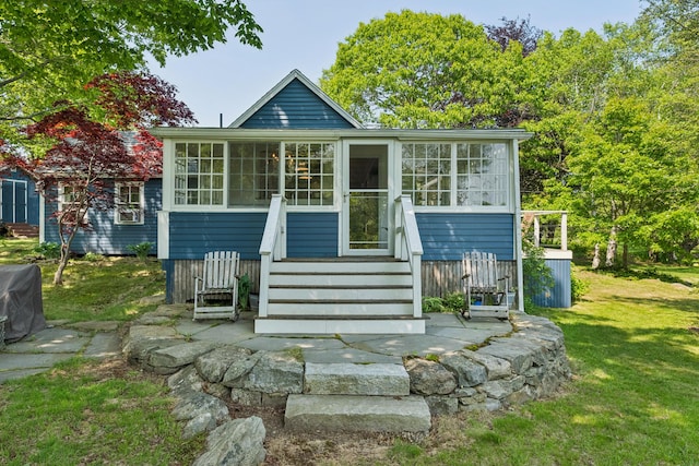 74 Ottawa Ave, Portland, ME 04109 - view of front of home featuring a sunroom and a front lawn