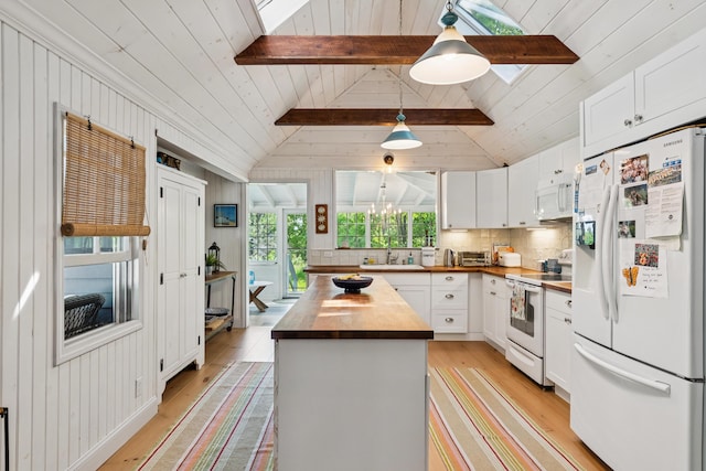 74 Ottawa Ave, Portland, ME 04109 - kitchen with white appliances, butcher block counters, light wood finished floors, white cabinets, and hanging light fixtures