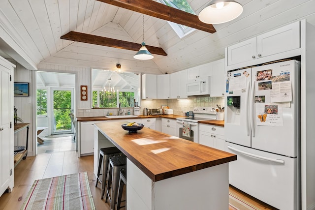 74 Ottawa Ave, Portland, ME 04109 - kitchen with butcher block countertops, white appliances, white cabinetry, decorative backsplash, and wood ceiling