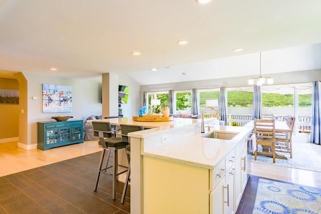 42 Barter Rd, Rockland, ME 04841 - kitchen featuring an island with sink, open floor plan, wood finished floors, light stone counters, and recessed lighting
