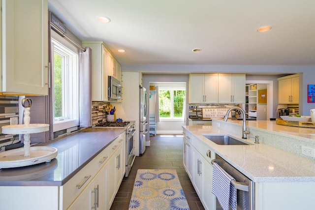 42 Barter Rd, Rockland, ME 04841 - kitchen with stainless steel appliances, recessed lighting, decorative backsplash, light stone countertops, and an island with sink