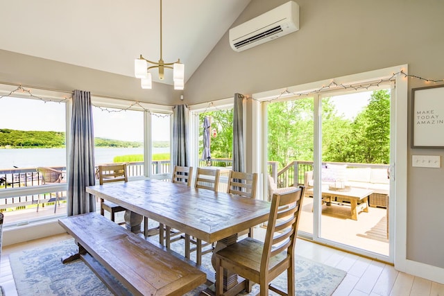 42 Barter Rd, Rockland, ME 04841 - dining area with a wall mounted air conditioner, light wood finished floors, a water view, high vaulted ceiling, and a chandelier