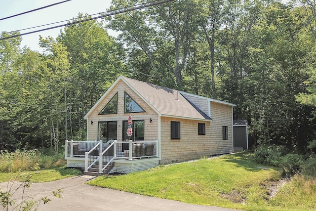42 Barter Rd, Rockland, ME 04841 - view of front of home with a front yard, roof with shingles, and a wooden deck