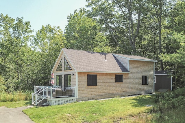 42 Barter Rd, Rockland, ME 04841 - view of front of house featuring a shingled roof, a front lawn, and a wooden deck