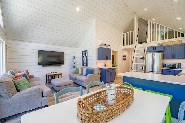 42 Barter Rd, Rockland, ME 04841 - living room with high vaulted ceiling, wooden walls, light wood-style flooring, a wall mounted air conditioner, and recessed lighting