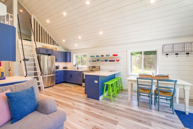 42 Barter Rd, Rockland, ME 04841 - kitchen featuring appliances with stainless steel finishes, a peninsula, a kitchen breakfast bar, light wood-style floors, and vaulted ceiling