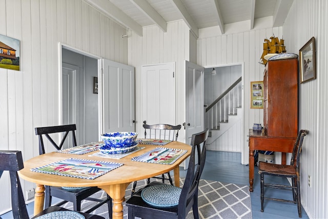 10 S Colony Branch Rd, Harpswell, ME 04079 - dining room with beamed ceiling, dark wood-style flooring, wooden walls, and stairs