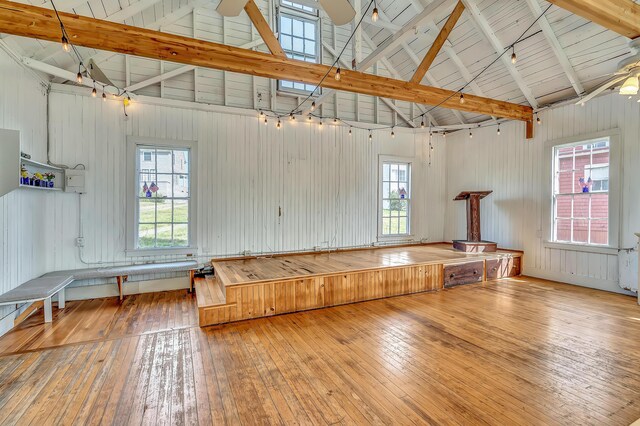 10 S Colony Branch Rd, Harpswell, ME 04079 - unfurnished room with a ceiling fan, hardwood / wood-style floors, high vaulted ceiling, beam ceiling, and wood walls