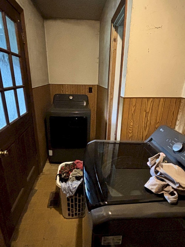 118 Athens Rd, Hartland, ME 04943 - bathroom featuring wainscoting, wooden walls, and washer and clothes dryer