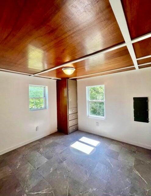 105 Arthur Allen Rd, Sumner, ME 04292 - unfurnished bedroom with wood ceiling with exposed beams, multiple windows, electric panel, and coffered ceiling