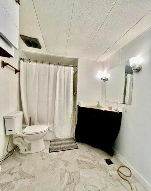 105 Arthur Allen Rd, Sumner, ME 04292 - bathroom featuring toilet, vanity, curtained shower, a textured ceiling, and marble finish floors