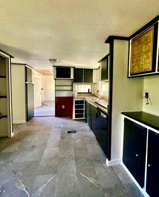 105 Arthur Allen Rd, Sumner, ME 04292 - kitchen featuring black dishwasher, a sink, and a textured ceiling