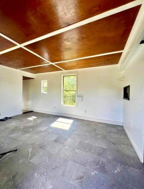 105 Arthur Allen Rd, Sumner, ME 04292 - unfurnished room with baseboards and beam ceiling