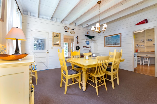51 W Marginal Rd, Brunswick, ME 04011 - dining space featuring a chandelier, wood walls, carpet flooring, and a wood ceiling with exposed beams
