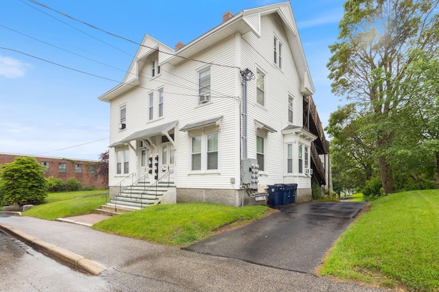 34 Birch St, Biddeford, ME 04005 - view of front of house featuring a chimney, a front lawn, and driveway