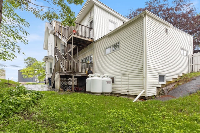 34 Birch St, Biddeford, ME 04005 - back of property featuring a balcony, a lawn, and a wooden deck