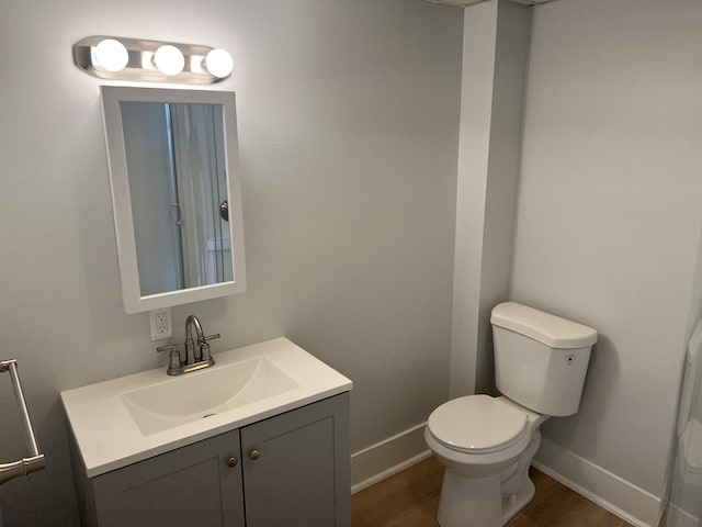 34 Birch St, Biddeford, ME 04005 - bathroom featuring vanity, baseboards, toilet, and wood finished floors