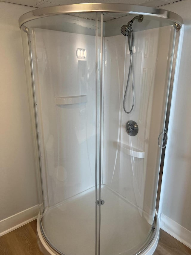 34 Birch St, Biddeford, ME 04005 - full bathroom featuring a shower stall, baseboards, and wood finished floors