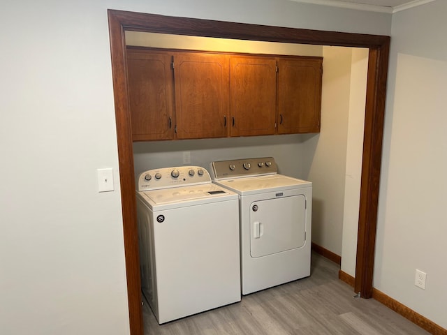 34 Birch St, Biddeford, ME 04005 - washroom featuring washer and dryer, cabinet space, light wood-type flooring, baseboards, and crown molding