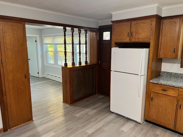 34 Birch St, Biddeford, ME 04005 - kitchen featuring freestanding refrigerator, a baseboard radiator, light wood-type flooring, brown cabinetry, and ornamental molding