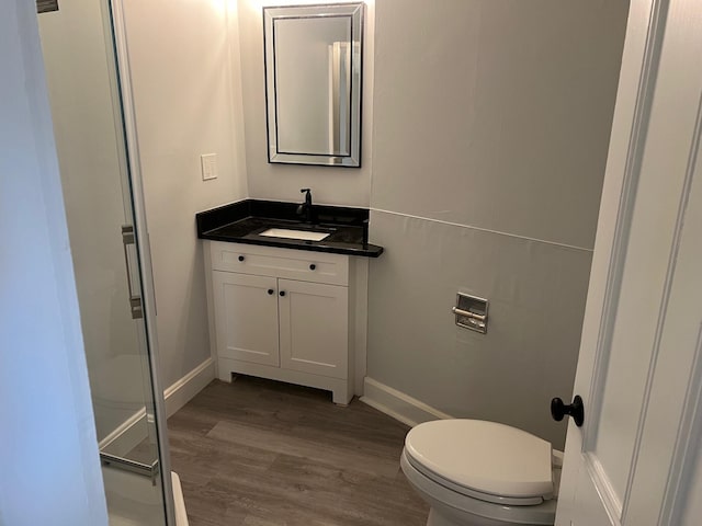 34 Birch St, Biddeford, ME 04005 - full bath featuring wood finished floors, vanity, toilet, and a stall shower