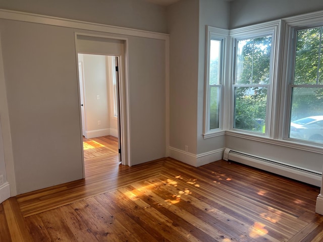 34 Birch St, Biddeford, ME 04005 - spare room with wood-type flooring, a baseboard heating unit, and baseboards