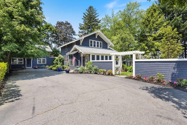 33 Rocky Ln, Ogunquit, ME 03907 - view of front facade with a chimney and asphalt driveway