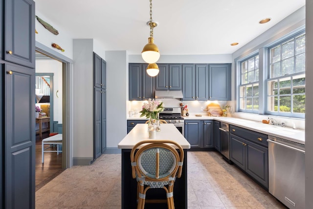 33 Rocky Ln, Ogunquit, ME 03907 - kitchen with appliances with stainless steel finishes, under cabinet range hood, light countertops, and decorative light fixtures