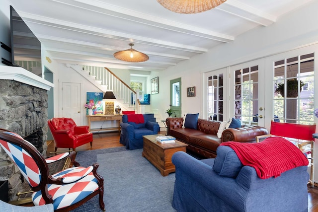 33 Rocky Ln, Ogunquit, ME 03907 - living room featuring stairway, wood finished floors, french doors, a fireplace, and beamed ceiling
