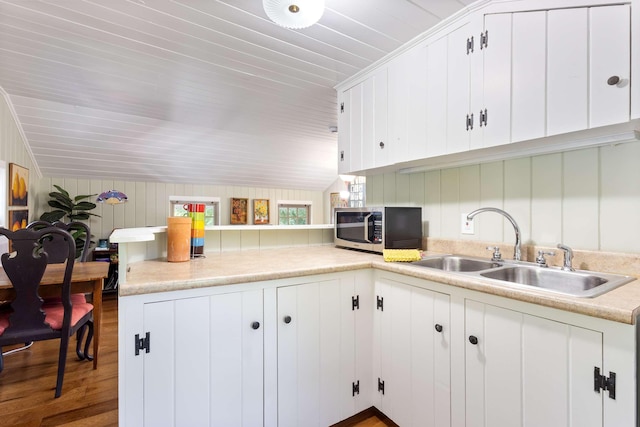 33 Rocky Ln, Ogunquit, ME 03907 - kitchen with stainless steel microwave, light countertops, white cabinets, wood finished floors, and wood ceiling