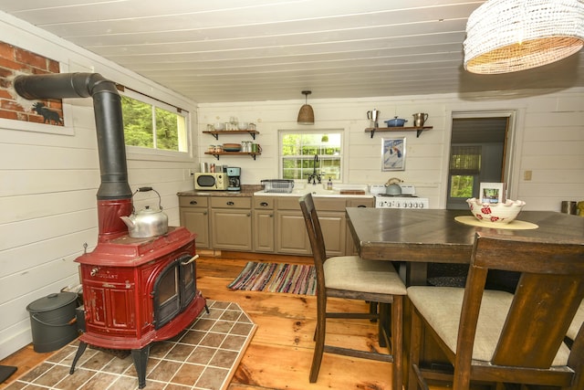 7 Cluff Ln, Bridgton, ME 04009 - dining area featuring a wood stove, wood finished floors, and wooden walls