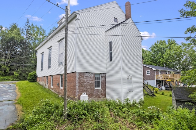 85 Friendship Rd, Waldoboro, ME 04572 - view of home's exterior featuring brick siding, a lawn, and a chimney