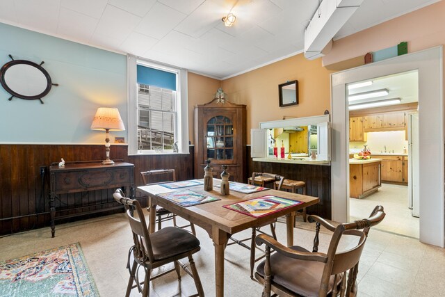 85 Friendship Rd, Waldoboro, ME 04572 - dining space with wood walls, light flooring, and a wainscoted wall